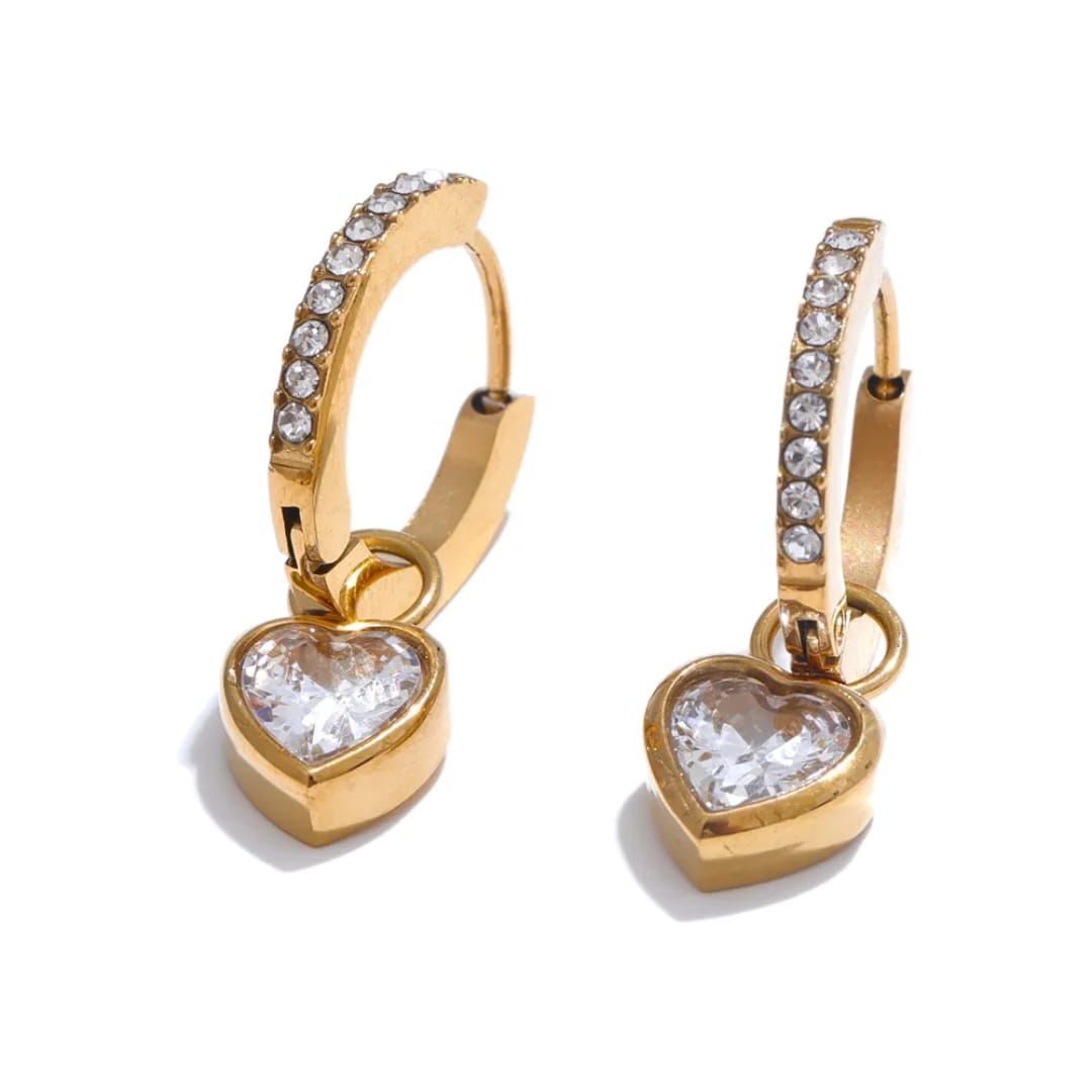 Gold heart-shaped earrings with clear gemstones on a white Gold Plated demi fine jewellery pvd technology which last 10 timesbackground