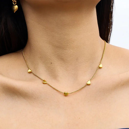 Gold heart-shaped necklace on a person with a neutral background Goldess Jewellry with pvd plating technology which last 10 times than normal jewelley 22