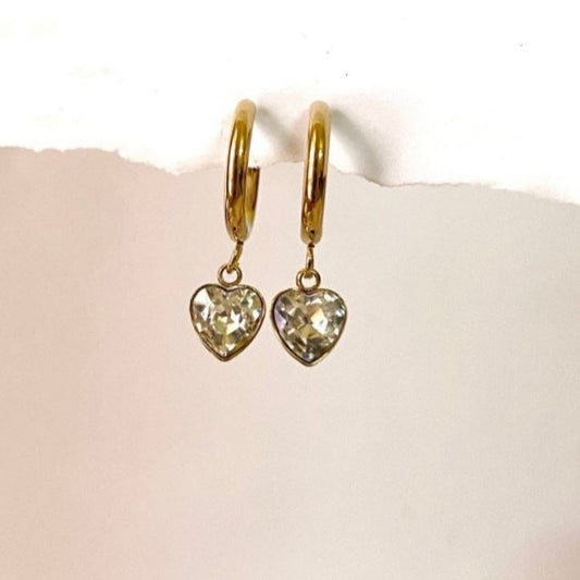 Gold heart-shaped earrings on a white background Goldess ewelley 18k pvd gold plating heart vip earings