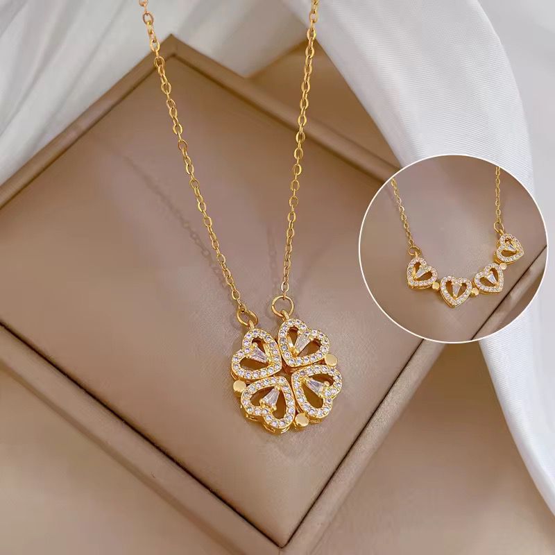 Gold necklace with a detailed pendant on a beige surface The everyday grace necklace 18k pure gold plated