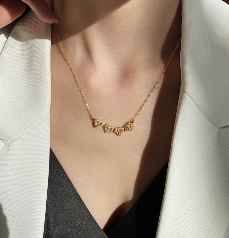 Gold necklace worn by a person with a white garment background The everyday grace necklace 18k pure gold plated