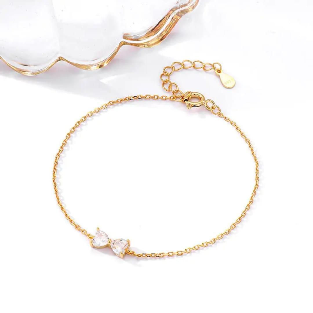 Gold bracelet with clear stones on a white background goldess jewellery 18k gold plated pvd technlogy