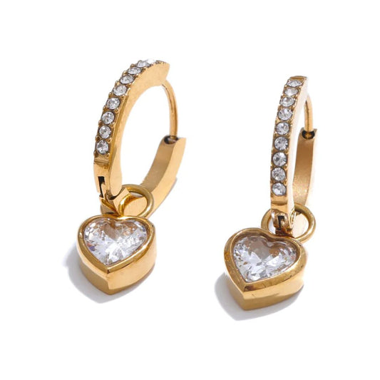 Gold heart-shaped earrings with clear gemstones on a white  Gold Plated demi fine jewellery pvd technology which last 10 timesbackground