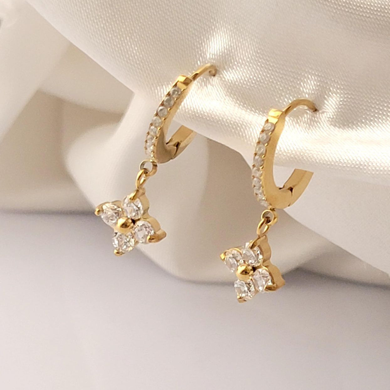 Gold hoop earrings with floral designs on a soft white background Gold plated earring anti tarnish