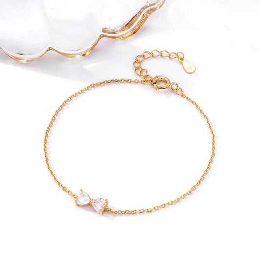 Gold bracelet with clear stones on a white background goldess jewellery 18k gold plated pvd technlogy